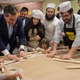 Cruz rolls matzah with some Jewish Americans.